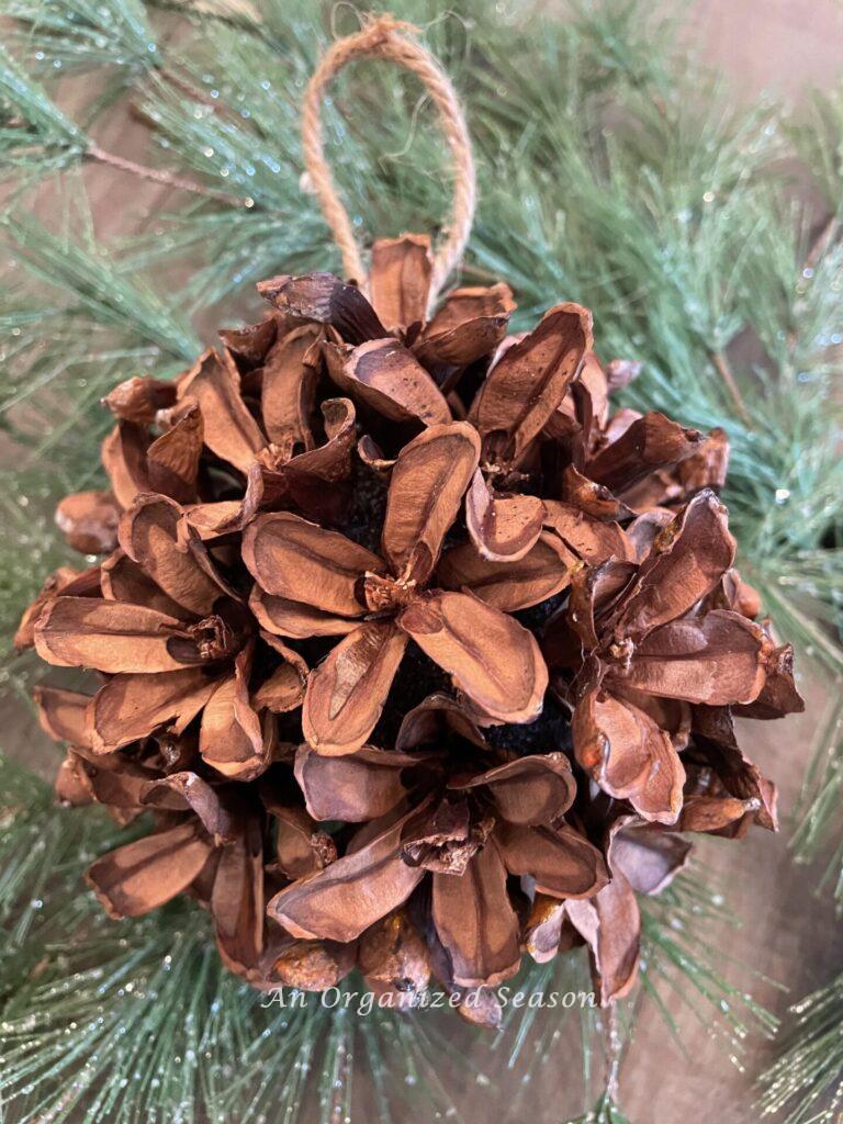A DIY pinecone flower ball ornament.