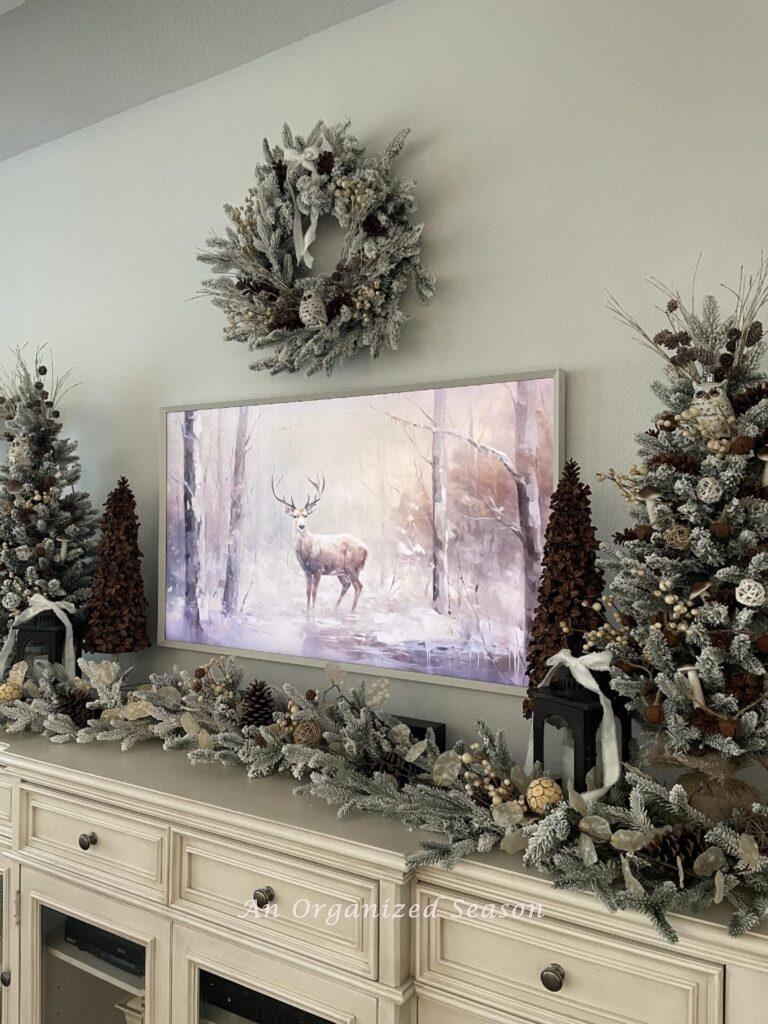 A TV console table decorated for Christmas.