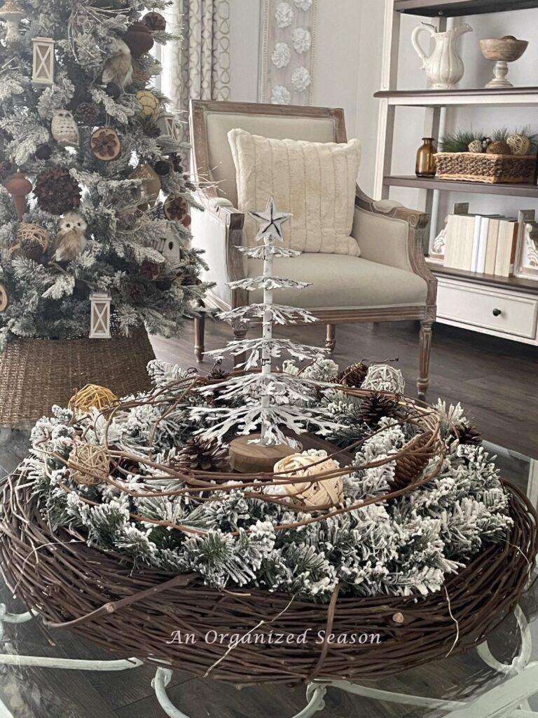 A Christmas centerpiece made out of two wreaths on a coffee table. 