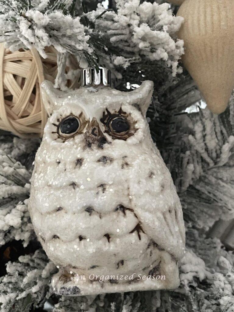 A white owl Christmas ornament. 