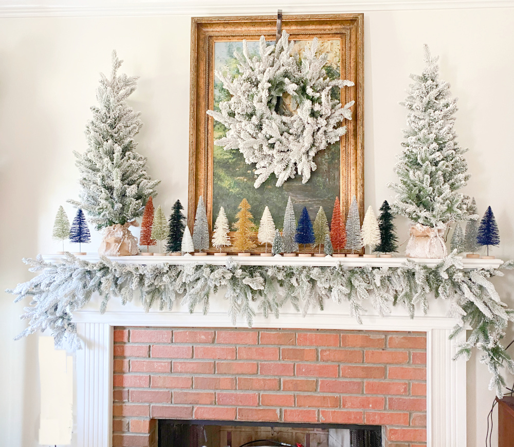 A King of Christmas queen flocked set decorating a mantle along with bottle brush trees.