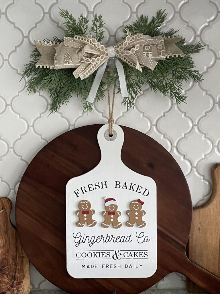 A gingerbread sign in front of a cutting board makes the perfect  Christmas kitchen decor.