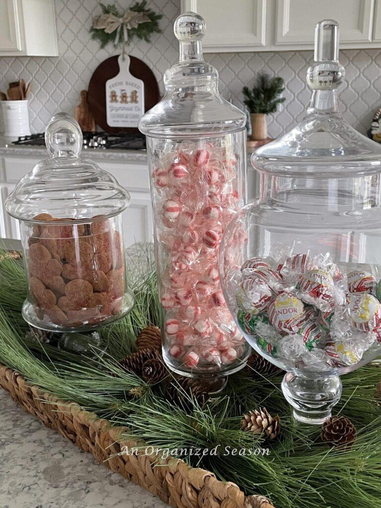 Apothecary jars filled with cookies and candy make perfect  Christmas kitchen decor.