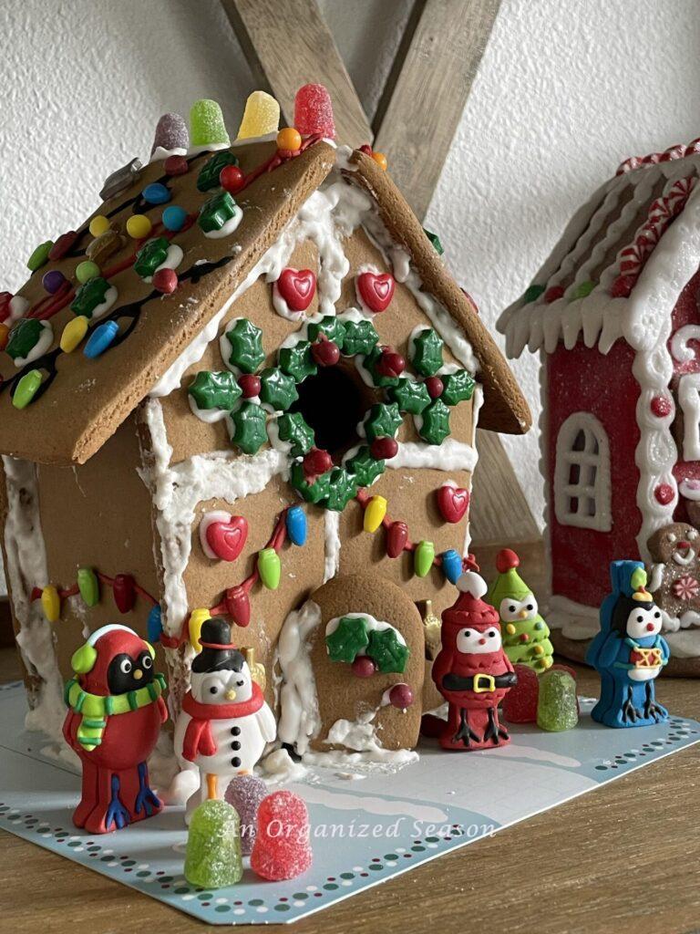 A decorated gingerbread house with birds dressed up makes the perfect  Christmas kitchen decor.