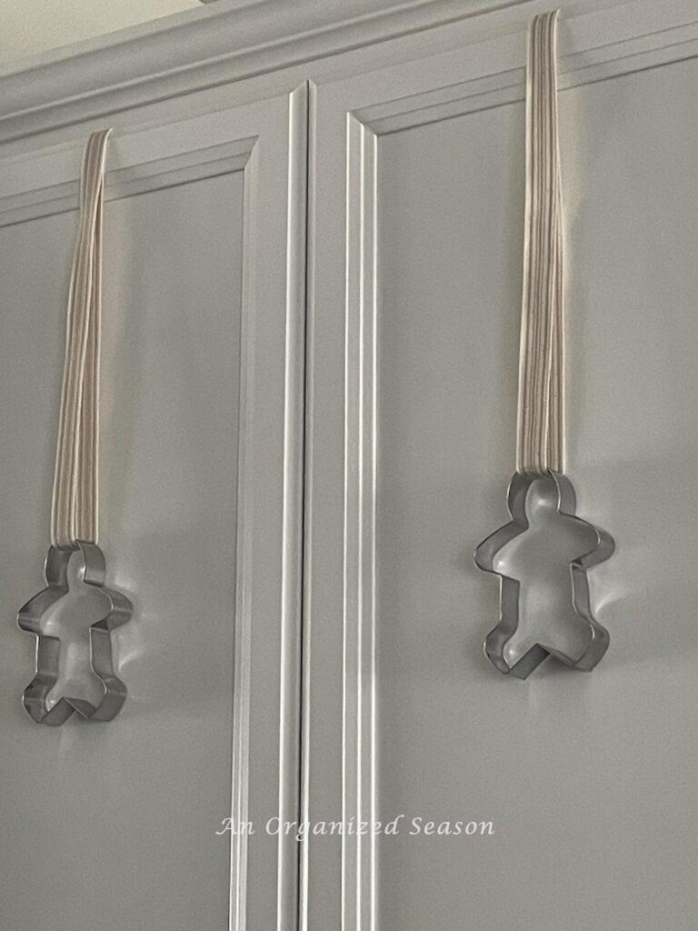 Cookie cutters hanging on a cabinet make perfect Christmas kitchen decor.