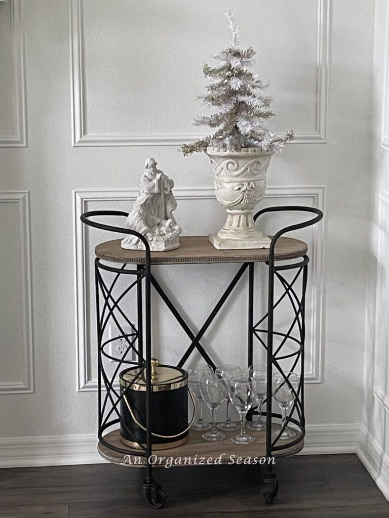 Bar cart with neutral Christmas tree and statue!