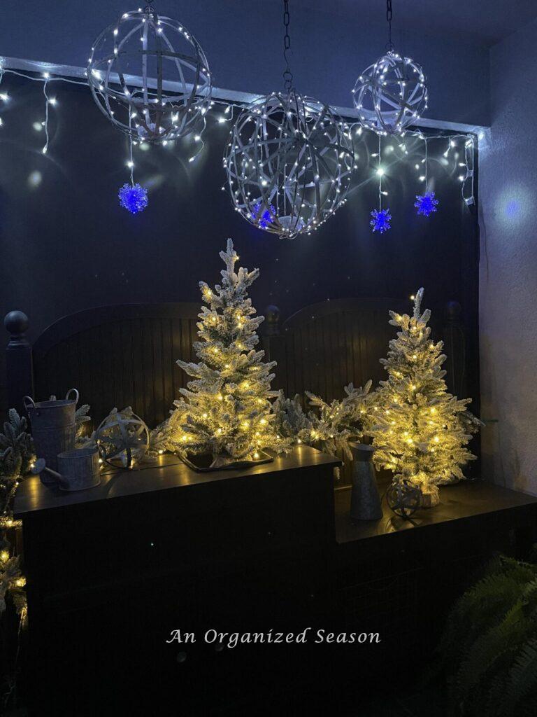 A potting bench and lanai decorated with lights for a Christmas home tour. 