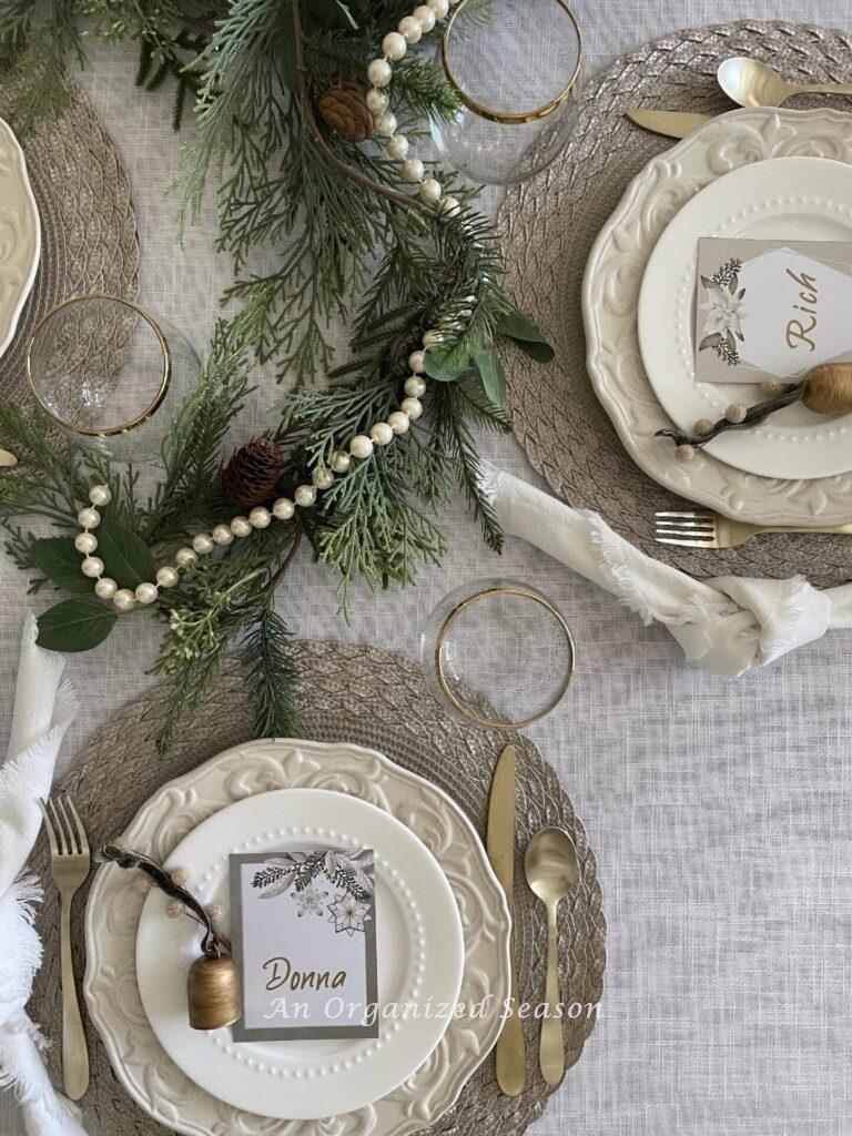 A dining table set for Christmas dinner in neutral colors. 