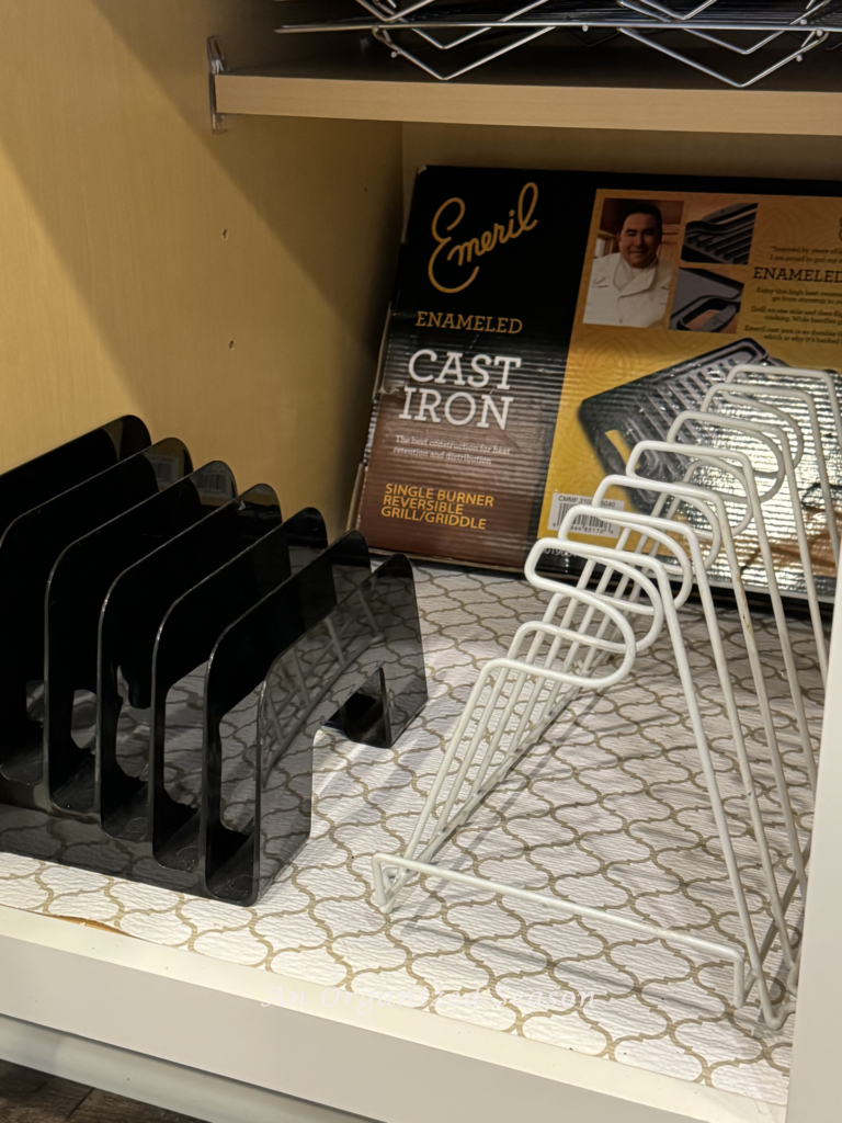 A black plastic mail file and a white lid organizer in a cabinet.