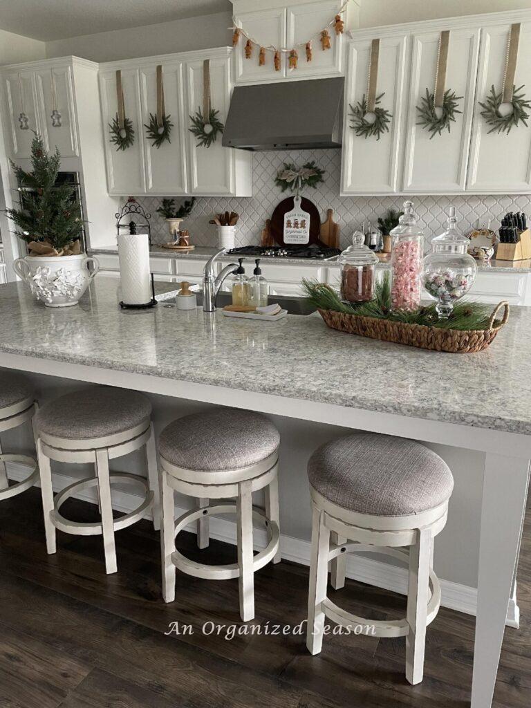 An organized kitchen decorated for Christmas. 