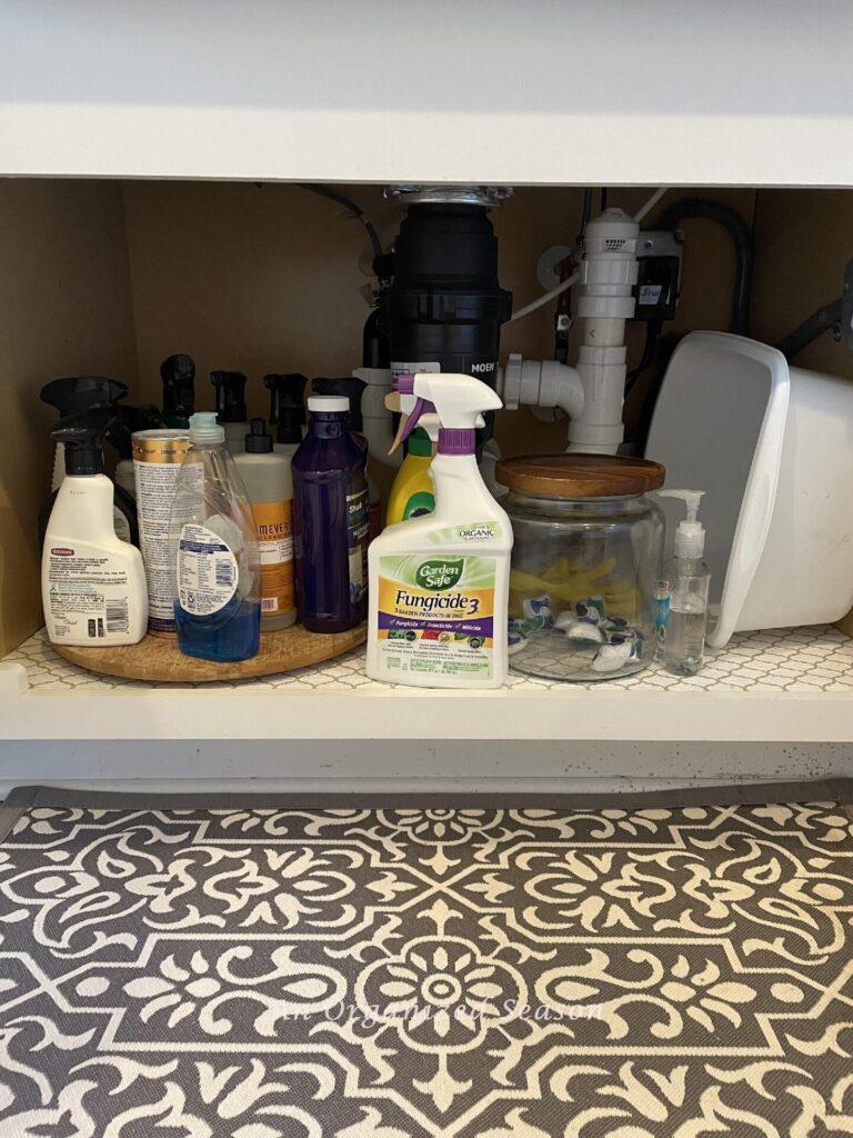 Messy items under a kitchen sink.