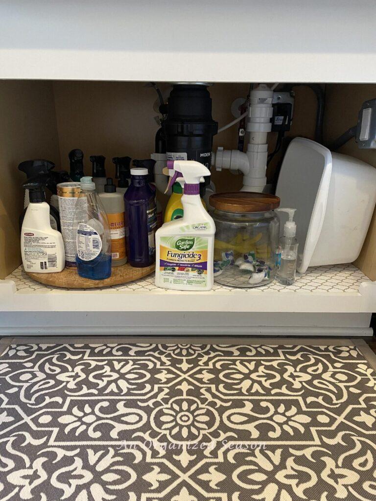 Cabinet under the kitchen sink that will be decluttered during the home organization challenge. 