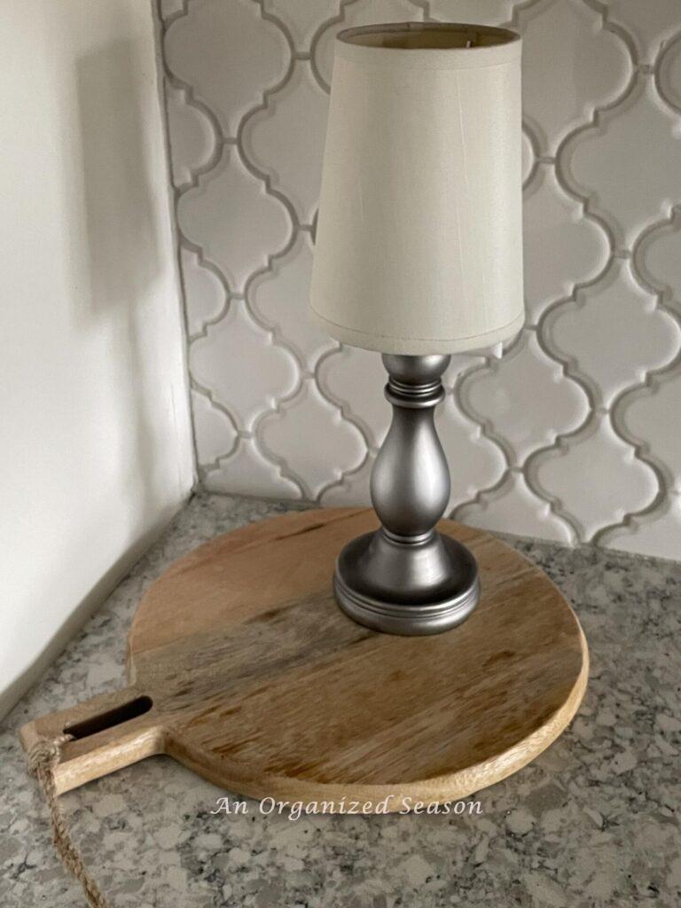 A cordless lamp on a cutting board.