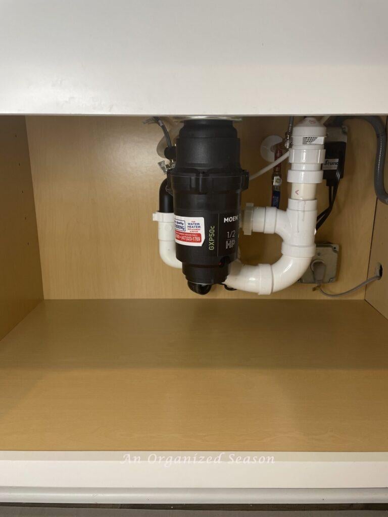 Empty cabinet under a kitchen sink.