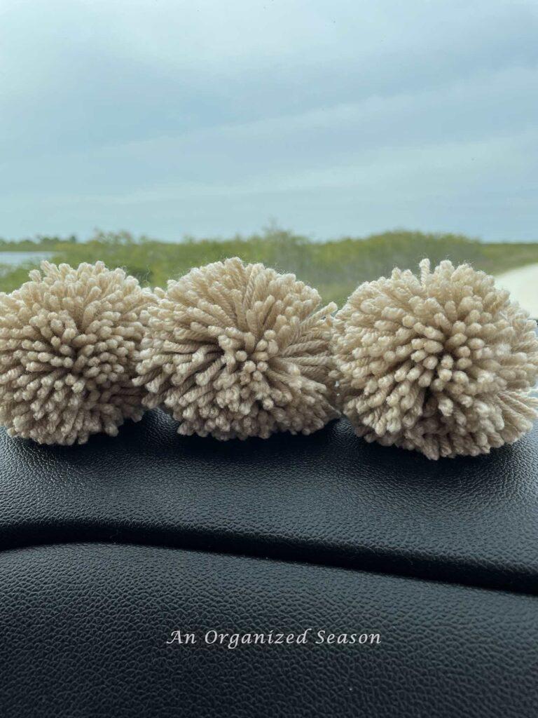 Three DIY pom poms.