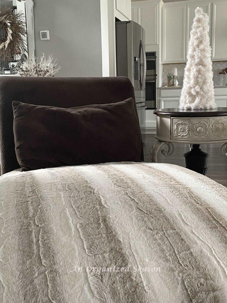 Add a faux fur throw blanket to a chaise lounge and it will double as Winter decor. 