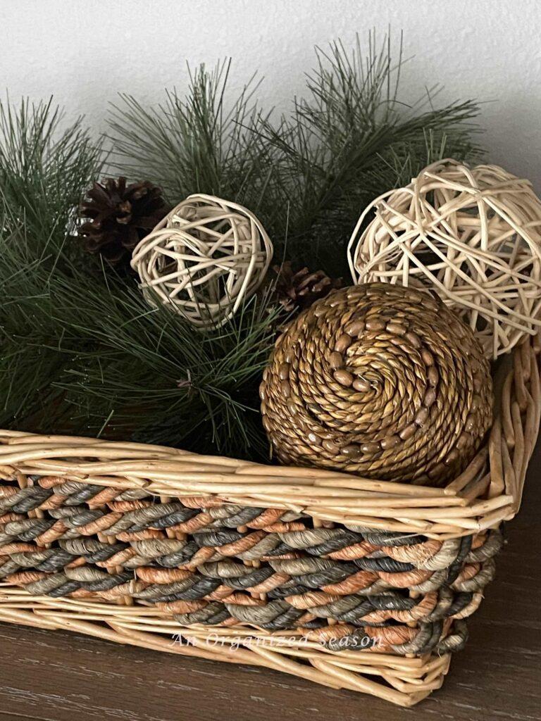 A basket filled with evergreen, pinecones and orbs makes easy Winter decor. 