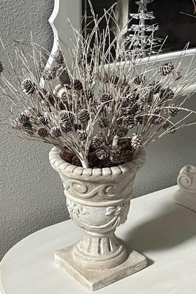 Pinecone picks arranged in an urn.