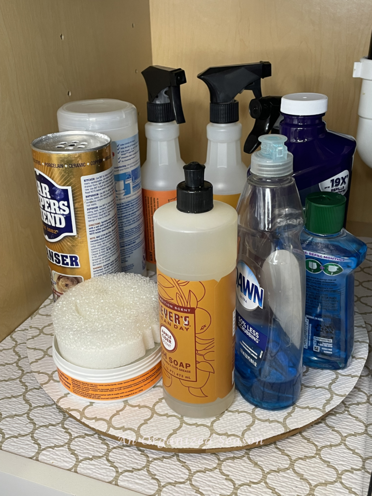 Under kitchen sink organization idea number three is to use a lazy Susan to hold cleaning products. 