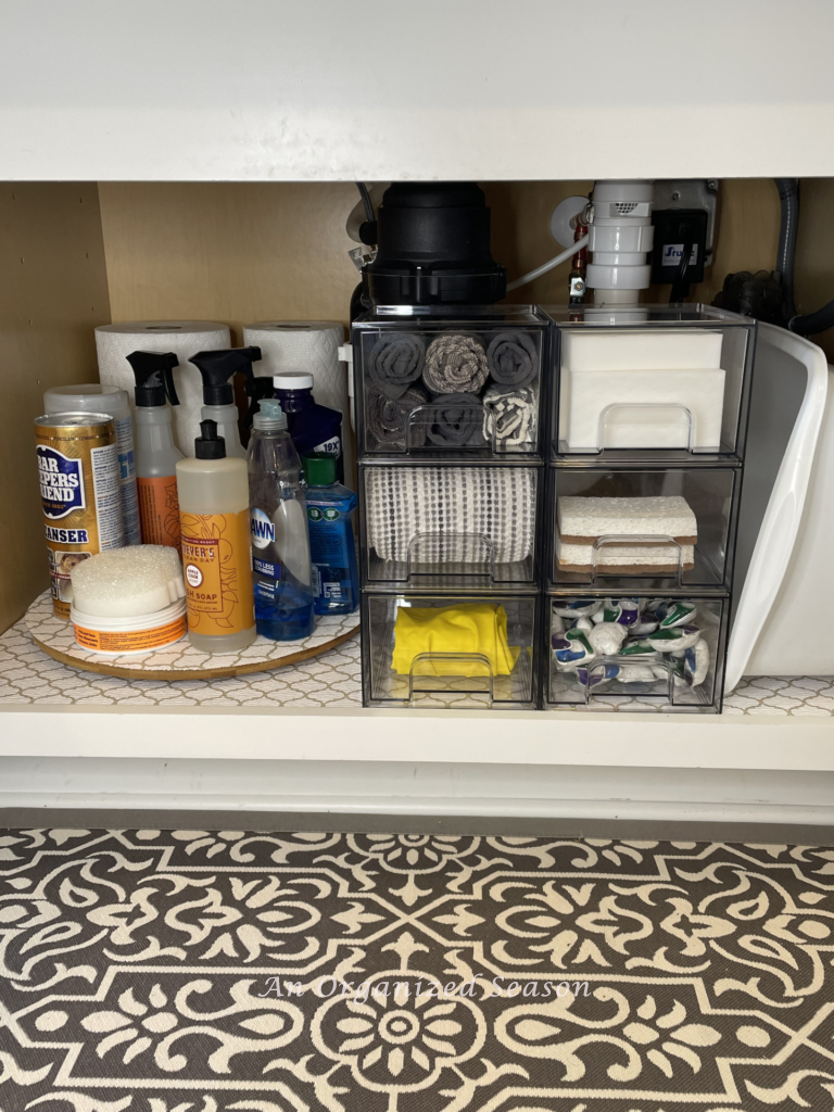 Cabinet organized with clear stackable drawers and a lazy Susan. 