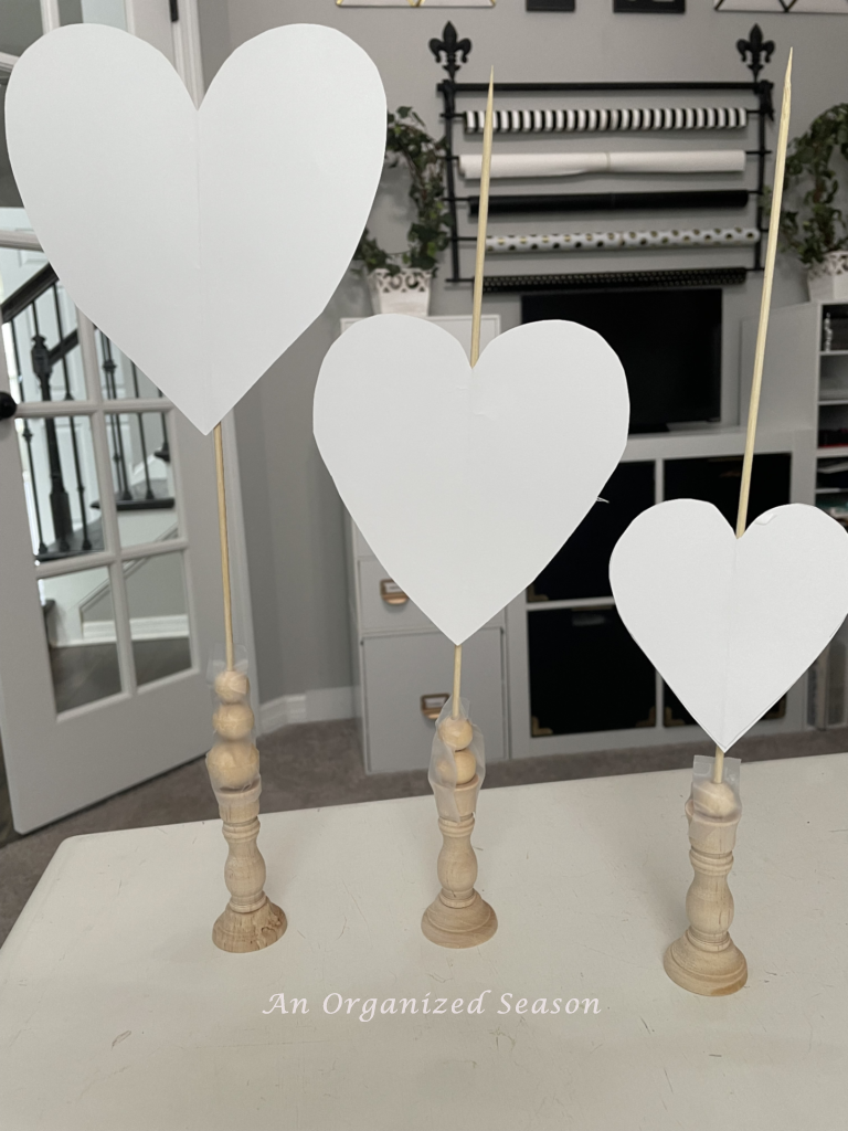 Three standing hearts made from wood and paper will make pretty DIY Valentines decor.