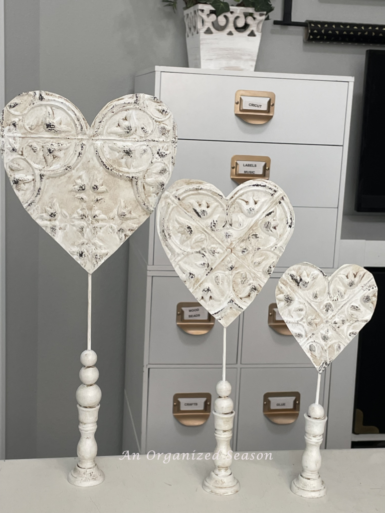 Three standing hearts made from Dollar Tree faux tin tiles.
