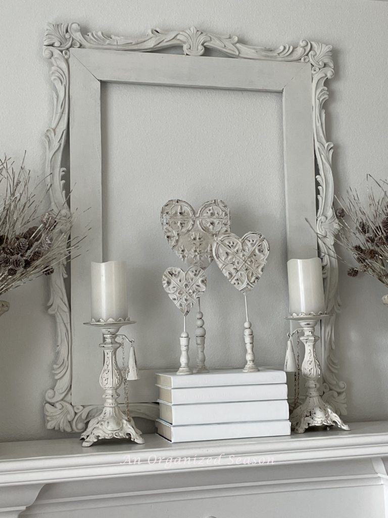 Three DIY standing hearts displayed on a mantel. 