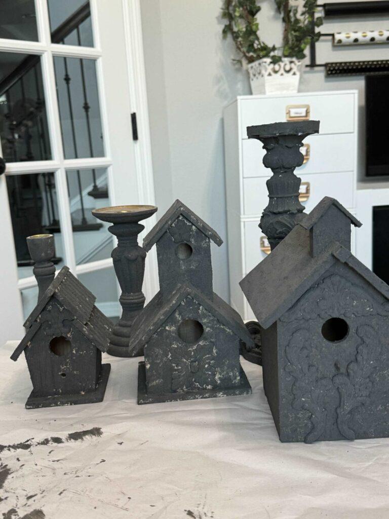 Birdhouses and candlesticks painted black. 