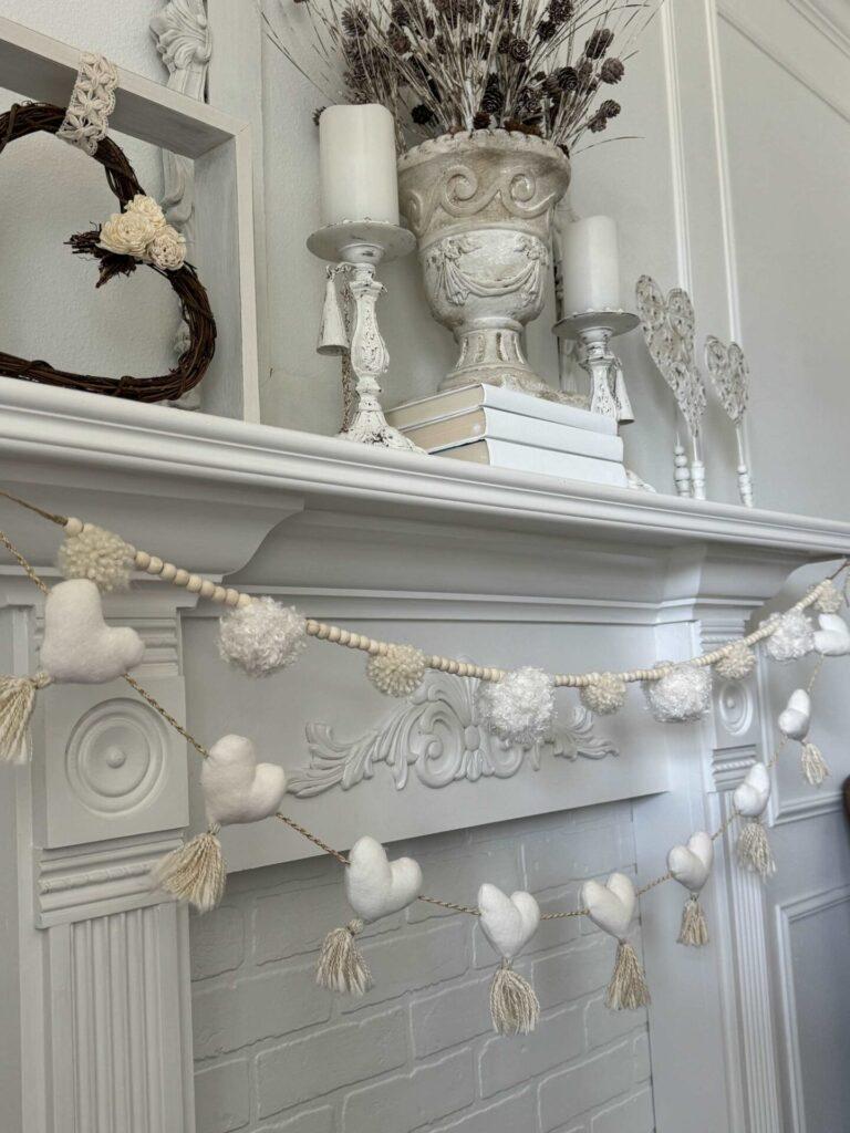 Two neutral garlands hanging on a mantel. 