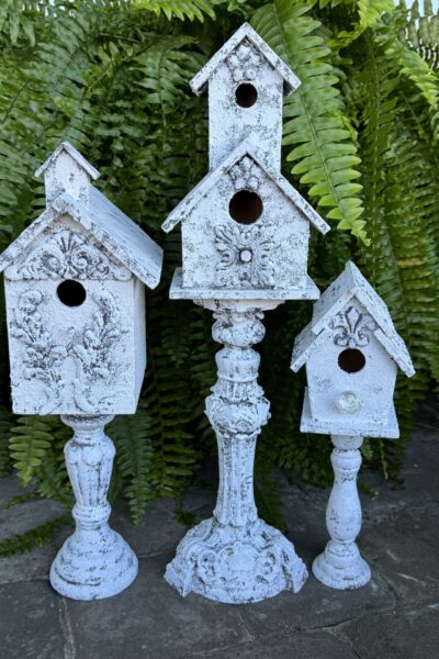 Three DIY birdhouses on pedestals