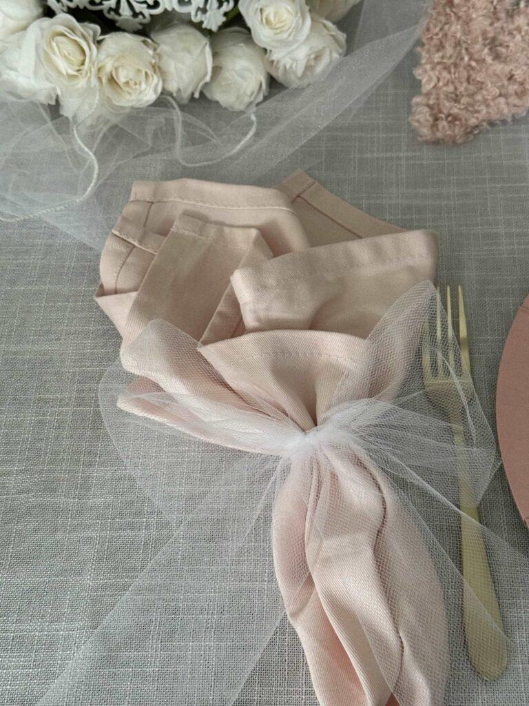A pink cloth napkin tied with a white tulle bow is perfect Valentine's table decor. 