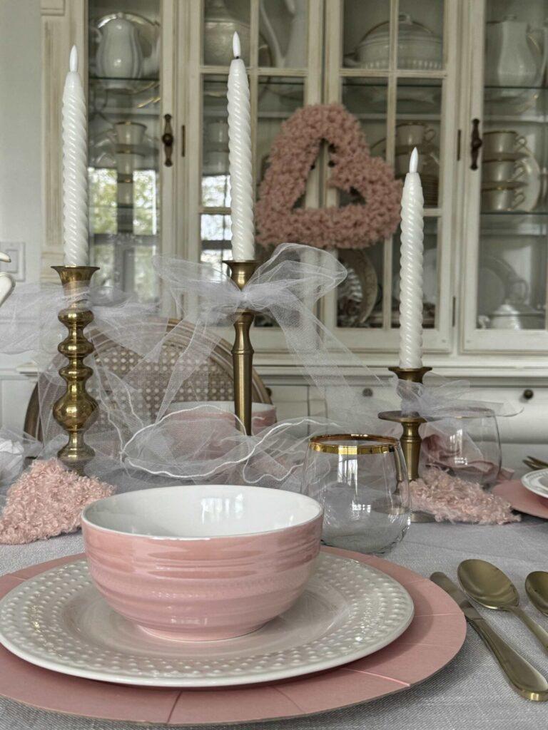 A pink and white place setting and gold candlesticks make beautiful Valentine's table decor. 