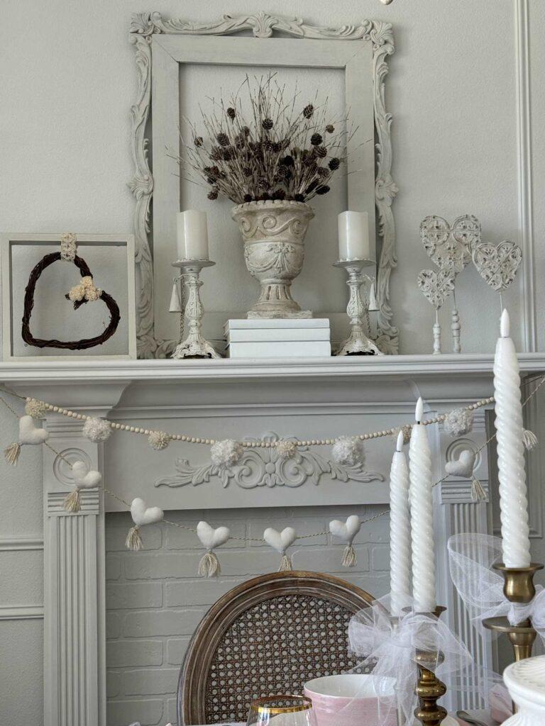 A white fireplace decorated with hearts for Valentine's Day.