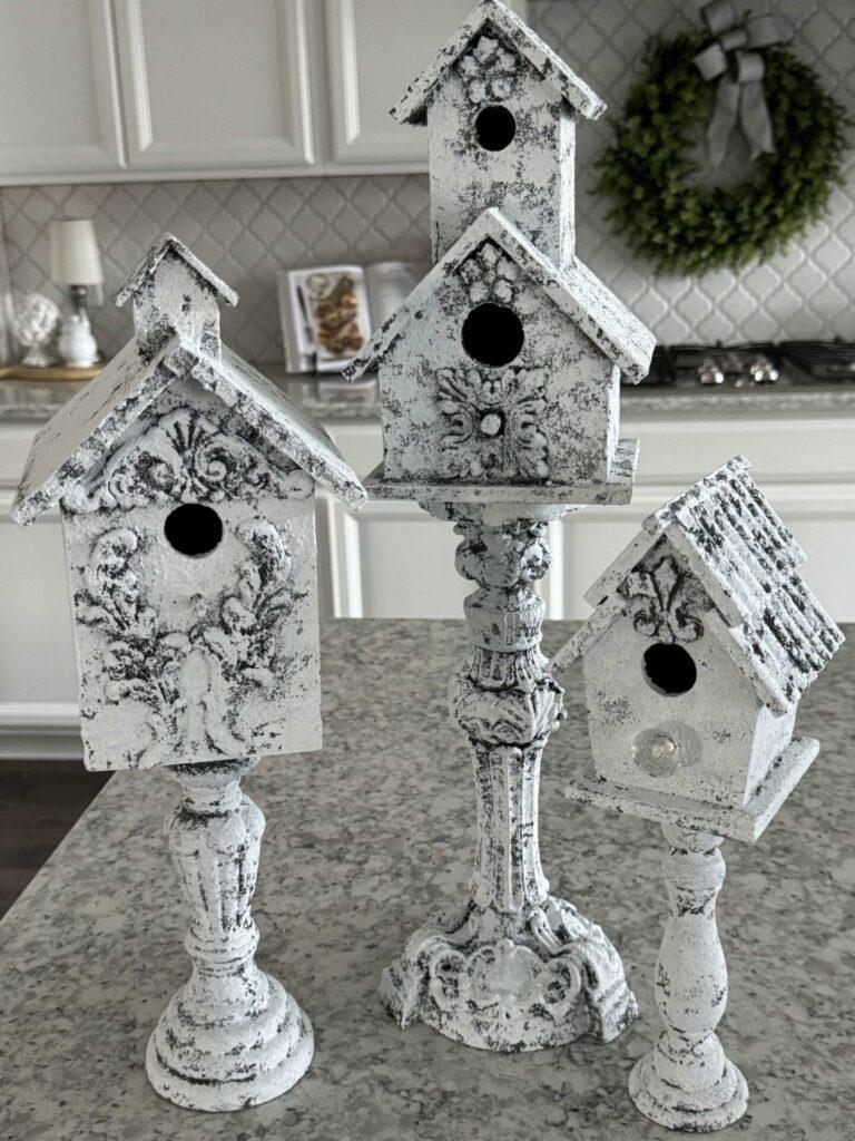 Three pedestal birdhouses in a kitchen used for Spring decor. 