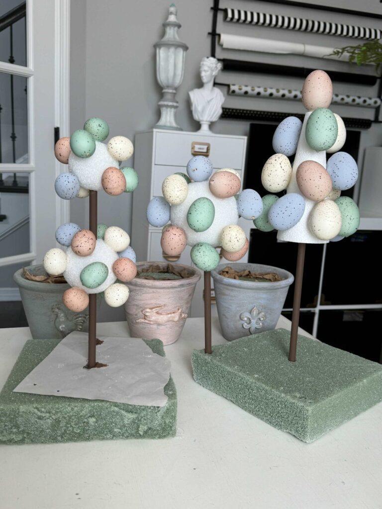 Step four to make an Easter egg topiary is to glue the eggs to the styrofoam. 