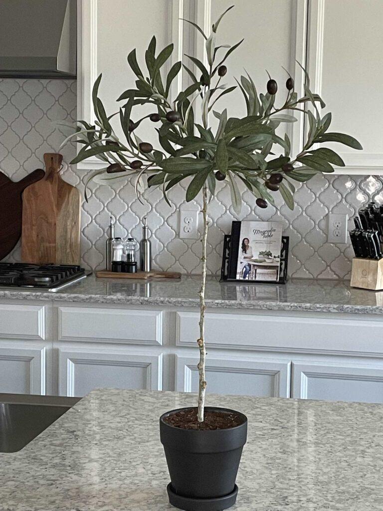 A DIY olive topiary on a kitchen counter. 