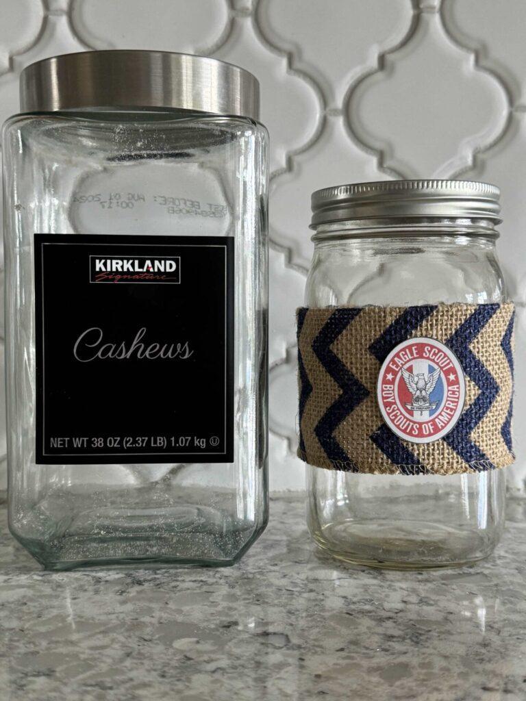 A cashew jar and a mason jar decorated with burlap. 