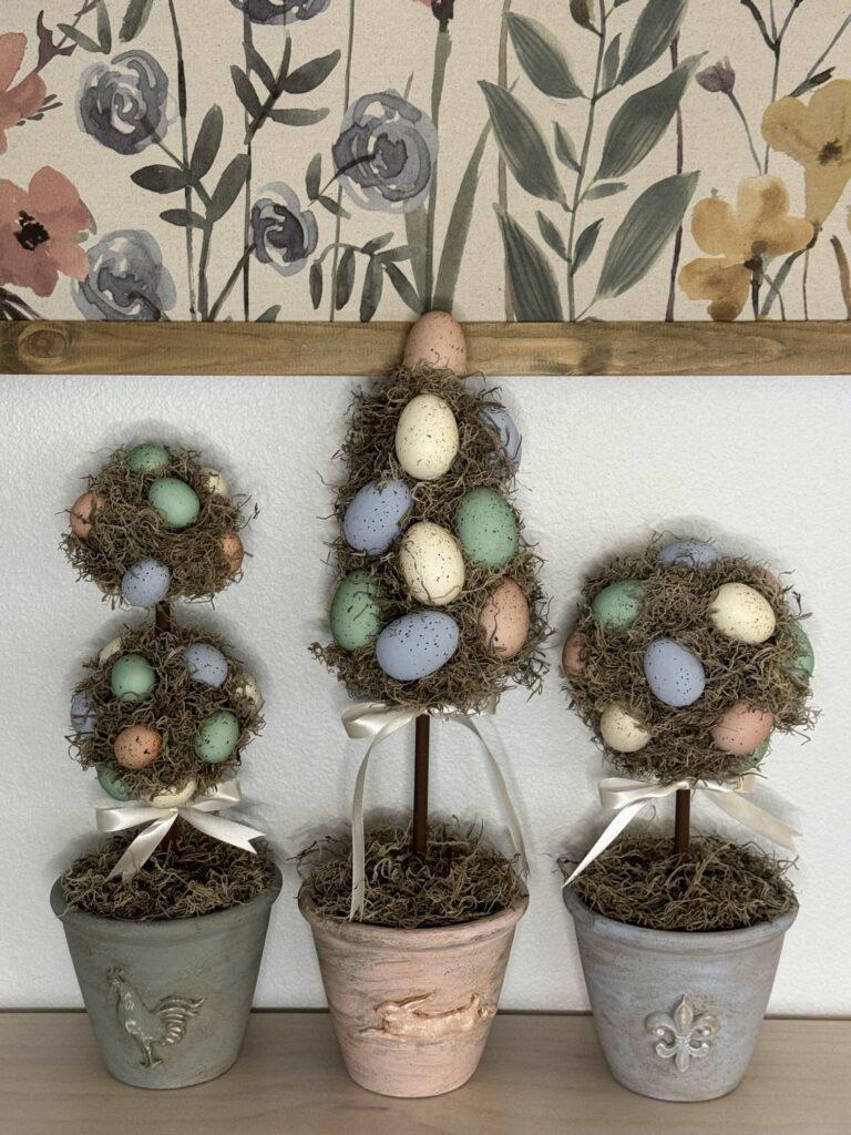 Three pastel colored egg topiaries.