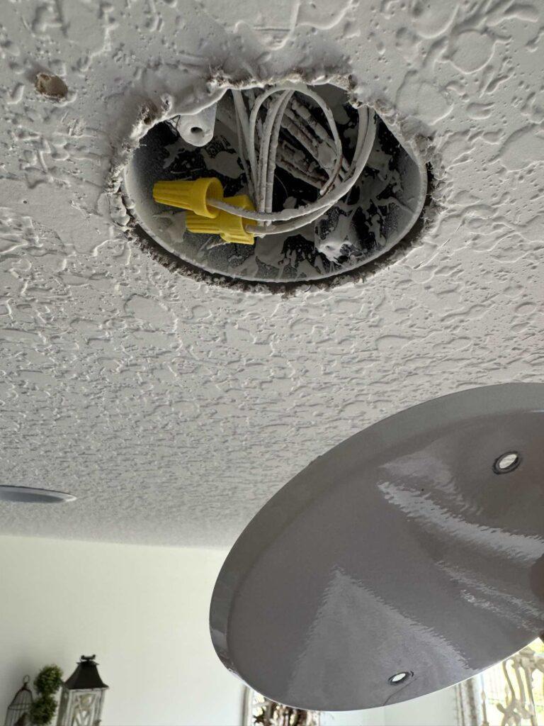 Ceiling fixture with exposed wires. 