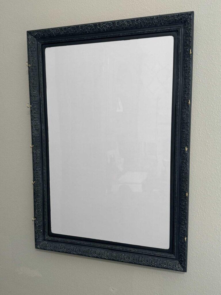 A black frame with cup hooks.