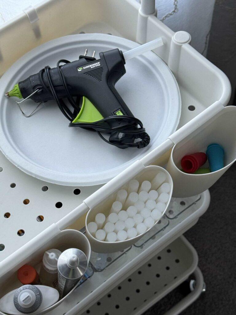 Craft room organization tip #6 is to store hot glue gun and accessories on a rolling cart. 