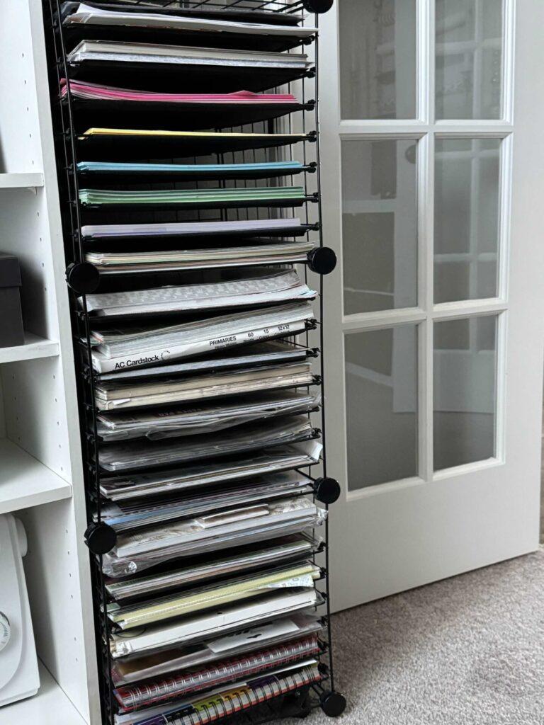 Craft room organization tip #10 is to store scrapbook paper in a paper organizer. 