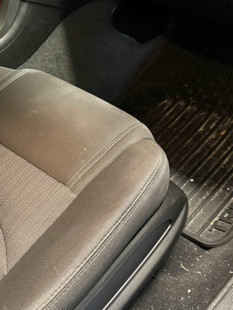Car with dirty seats and sandy floor. 