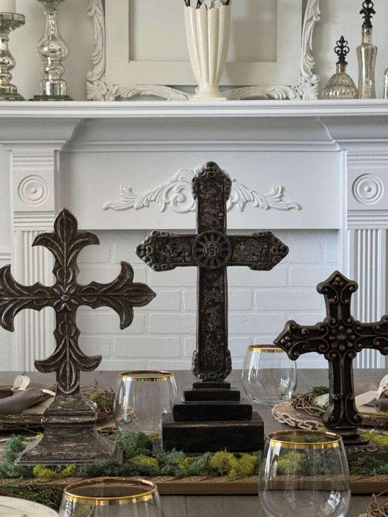 Easter table centerpiece with three cross statues. 