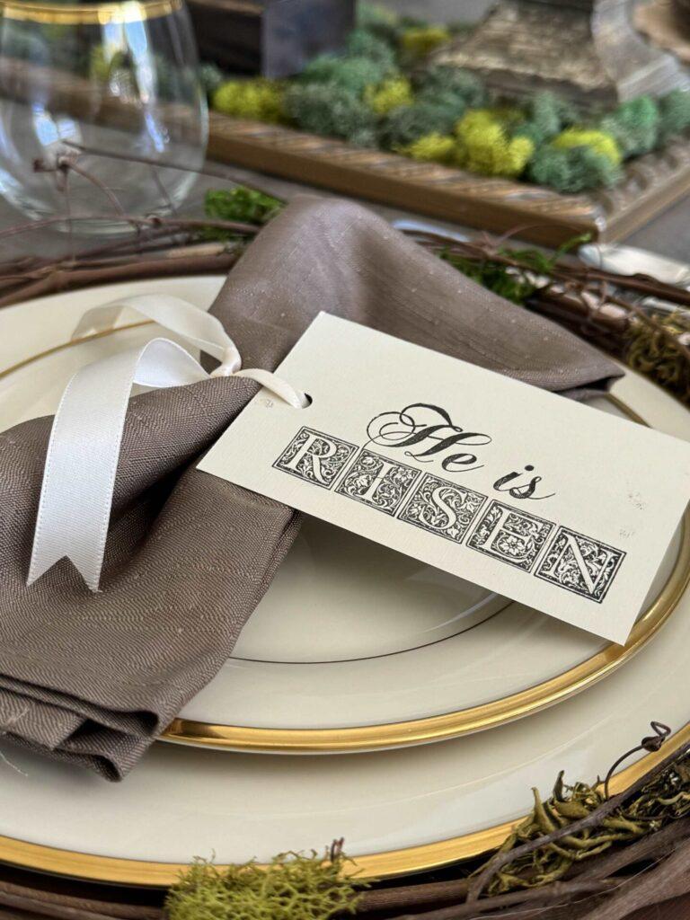 Stamped "He is risen" napkin holder is a good idea for Easter table decor.
