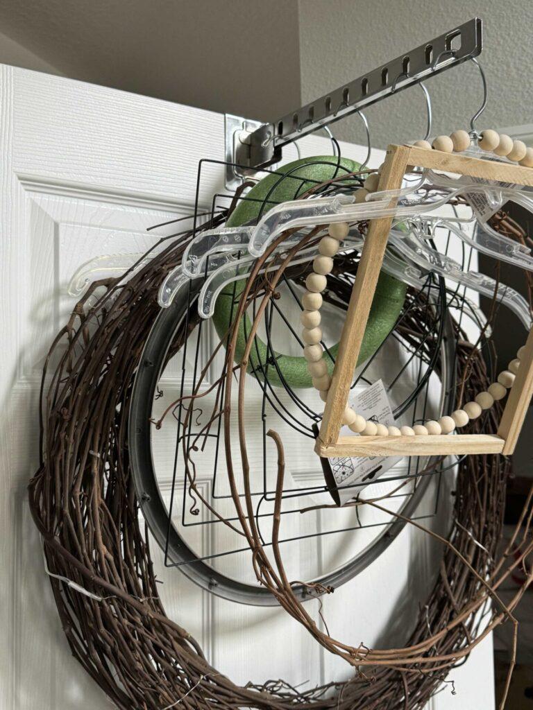 Craft room organization tip #3 is to hang wreaths and forms on an over-the-door- holder. 