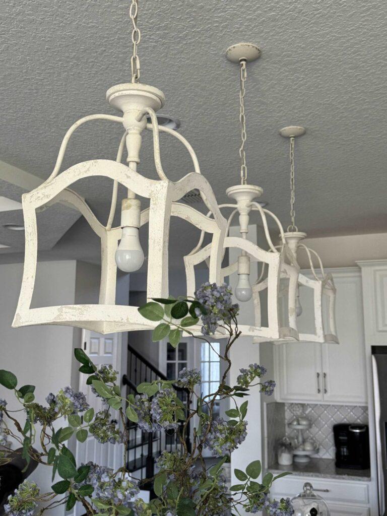 Three vintage looking pendant lights hanging in a kitchen. 