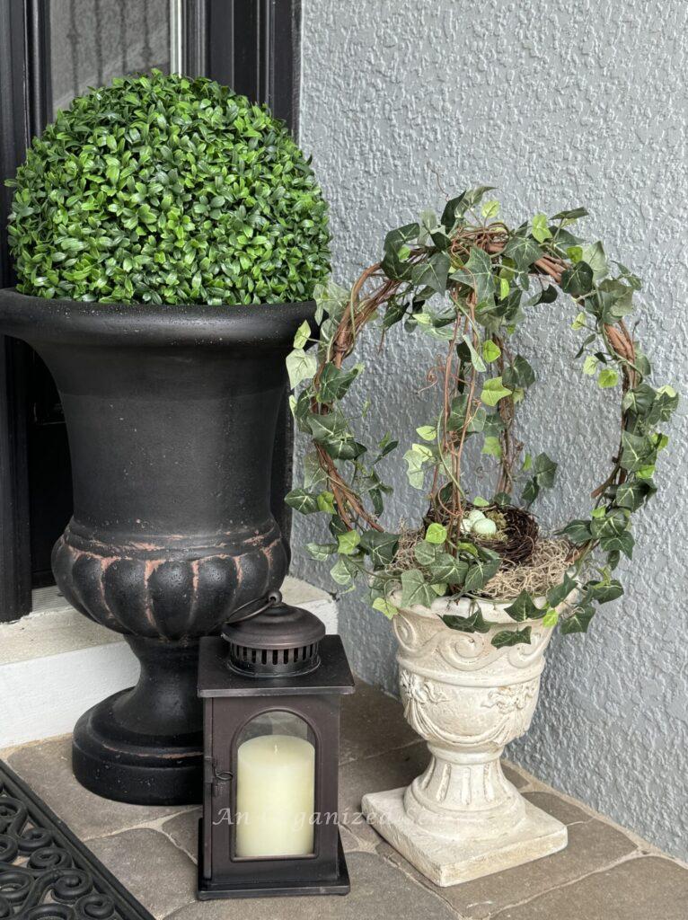 Spring porch decor idea #3 is to add faux topiaries to planters.