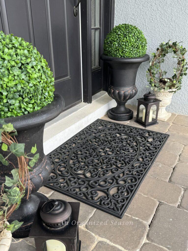 Spring porch decor idea #4 is to add a pretty doormat to your porch. 