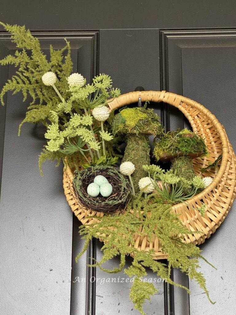 Spring porch decor idea #1 is to hang a seasonal wreath on the front door.